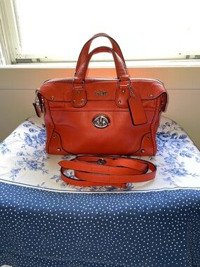 COACH RHYDER 24 IN VERMILLION LEATHER-PERFECT COLOR FOR SPRING/SUMMER.